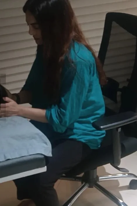 Vibha Jain working attentively with a client resting on a therapy couch